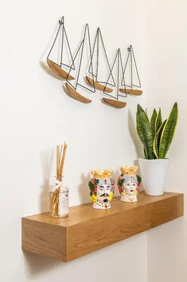 a wooden shelf with three vases and a plant at Bed & Theatre - Palermo in Palermo
