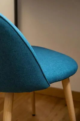 a blue chair sitting on top of a wooden floor at Bed & Theatre - Palermo in Palermo