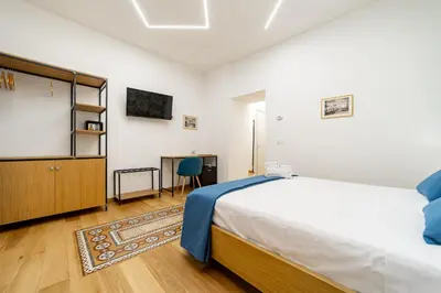 a bedroom with a bed and a chalkboard on the wall at Bed & Theatre - Palermo in Palermo