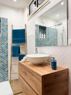 a bathroom with a white bowl sink on a wooden counter at Casa Nonna Pina in Palermo