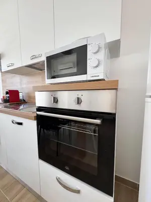 a kitchen with a microwave above a oven at Casa Nonna Pina in Palermo