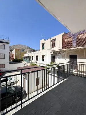 a balcony with a fence and a parking lot at Casa Nonna Pina in Palermo
