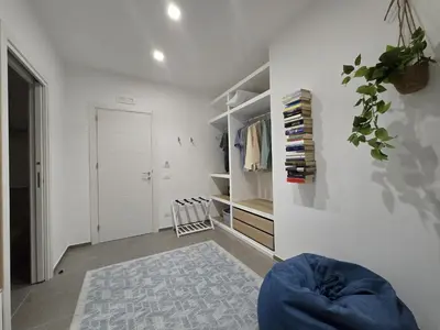 a white room with a closet and a door at Domus Minerva in Palermo