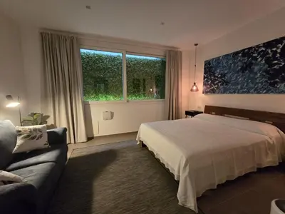 a bedroom with a bed and a couch and a window at Domus Minerva in Palermo