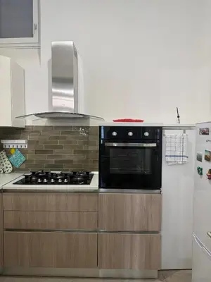 a kitchen with a stove and a refrigerator at santa Rosalia home in Palermo