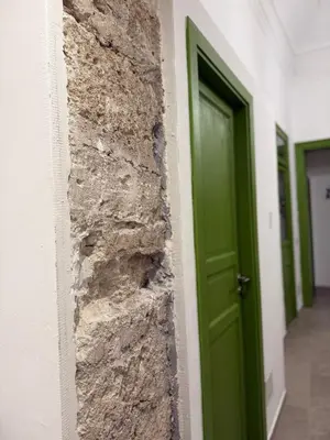 a hallway with a green door in a building at santa Rosalia home in Palermo