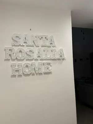 a white wall with a sign that reads santa rosa hospital home at santa Rosalia home in Palermo