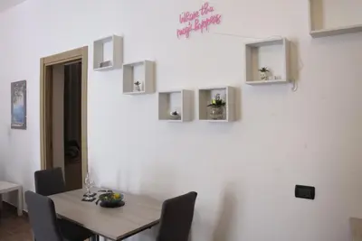 a dining room with a wooden table and chairs at Romantichouse in Palermo
