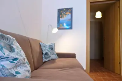 a room with a couch and a neon sign on the wall at Romantichouse in Palermo