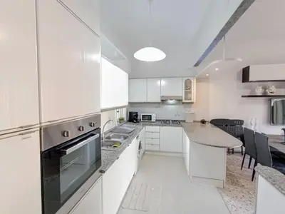 a kitchen with white cabinets and a counter top at Casa Hyccarina in Carini