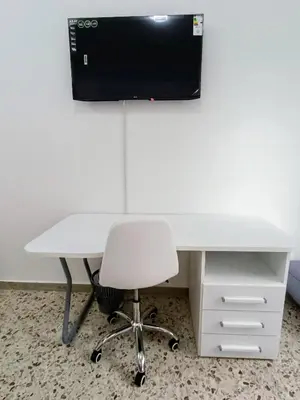 a white desk with a chair and a television at Casa Hyccarina in Carini