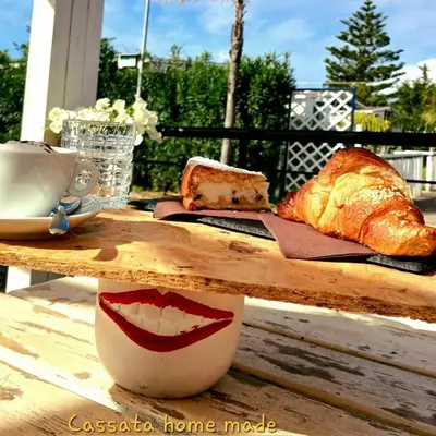 a table with a plate of bread and a cup of coffee at lia&gio' in Campofelice di Roccella
