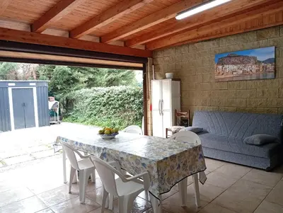 a living room with a table and chairs and a couch at lia&gio' in Campofelice di Roccella