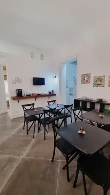 a group of tables and chairs in a room at Le Suite Vintage del Corso in Palermo