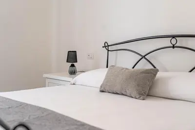 a bedroom with a white bed and a lamp at Casa Florio Love Palermo in Palermo