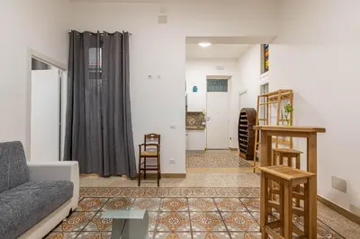 a living room with a couch and a table at Casa Florio Love Palermo in Palermo