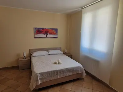 a bedroom with a bed with a stuffed animal on it at Sicily's Garden in Bagheria