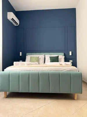 a blue bedroom with a bed with a blue wall at Magione House Rooms in Palermo