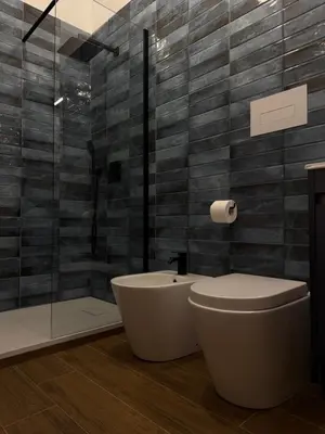a bathroom with a tub and a toilet and a shower at Magione House Rooms in Palermo