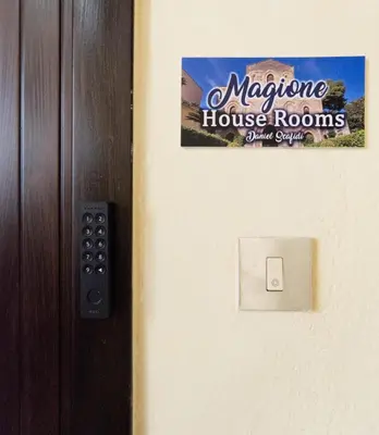 a sign on the door of a house room at Magione House Rooms in Palermo
