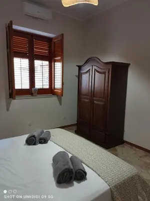 a bedroom with a bed with two towels on it at Il Gelsomino in Bagheria