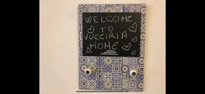 a chalkboard with a sign that says welcome a to a vegetarian movie at Casa vucciria in Palermo