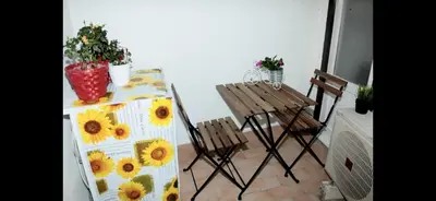 a table and chairs in a room with sunflowers at Casa vucciria in Palermo
