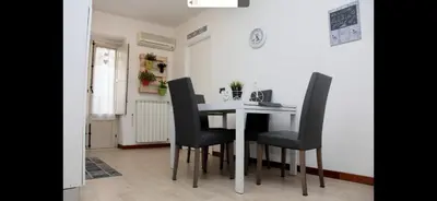 a dining room with a table and black chairs at Casa vucciria in Palermo