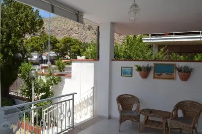 a balcony with chairs and a view of a mountain at Villa Eugenia - Mondello Beach in Palermo