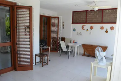 a living room with tables and chairs and a ceiling at Villa Eugenia - Mondello Beach in Palermo
