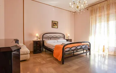 a bedroom with a bed and a chandelier at Cozy Apartment In Trappeto With Wifi in Trappeto