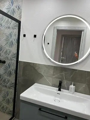 a bathroom with a white sink and a mirror at NR Apartment in Palermo