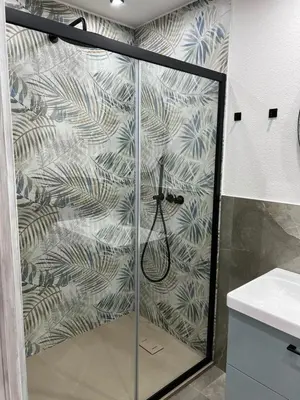 a shower with a glass door in a bathroom at NR Apartment in Palermo