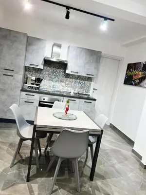 a dining room with a table and chairs in a kitchen at NR Apartment in Palermo