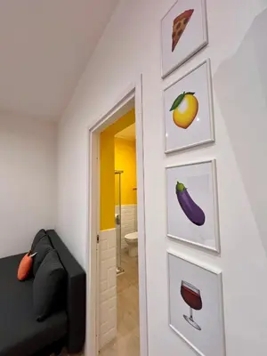 a room with a door with pictures of fruits and vegetables at GiraSole in Palermo
