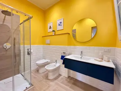 a bathroom with a toilet and a sink and a shower at GiraSole in Palermo