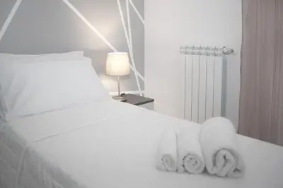 a white bed with two folded towels on it at Montalcini 3 in Capaci