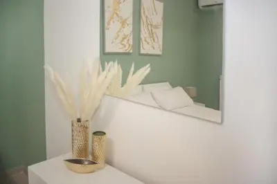 a room with a mirror and a vase on a table at Montalcini 3 in Capaci