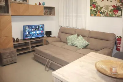 a living room with a couch and a flat screen tv at Montalcini 3 in Capaci