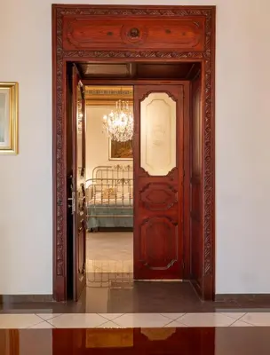 an entrance to a room with a wooden door at Artista Apartment in Alcamo