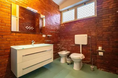 a bathroom with a white sink and a toilet at Solemar Sicilia - Villa Giovitto in Bagheria