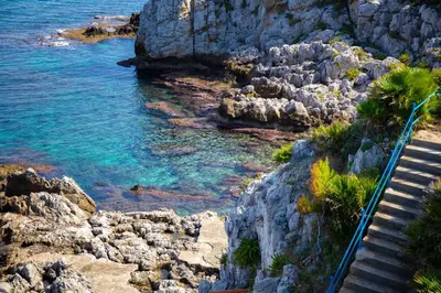 a group of stairs leading down to a rocky beach at Solemar Sicilia - Villa Giovitto in Bagheria