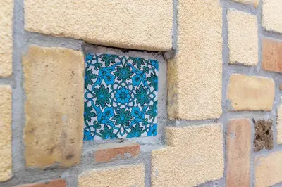a window in a brick wall with a blue tile at Historic soul apartment in Palermo