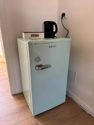 an old refrigerator with a kettle on top of it at Corte Panormus in Palermo