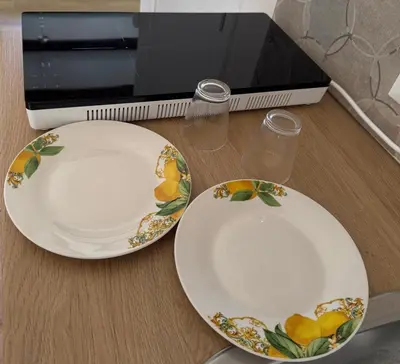 two plates sitting on a counter next to a microwave at Corte Panormus in Palermo