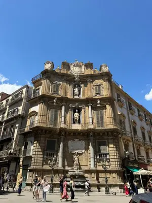 a large building with people walking in front of it at Corte Panormus in Palermo