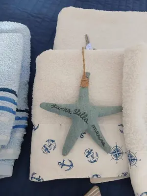 a towel with a starfish on it next to towels at La casa di Tiziana in Castellammare del Golfo