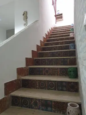 a staircase with mosaic tiles on the stairs at La casa di Tiziana in Castellammare del Golfo