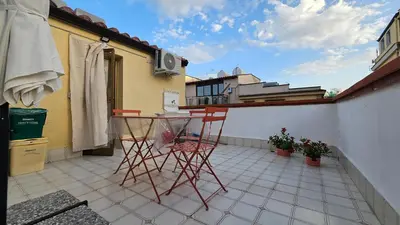 a patio with two chairs and a table on a balcony at 