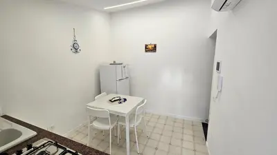 a kitchen with a white table and a refrigerator at 